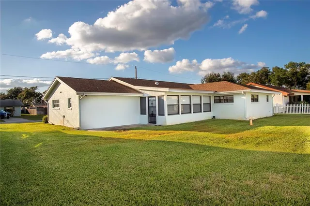 a front view of house with yard and swimming pool
