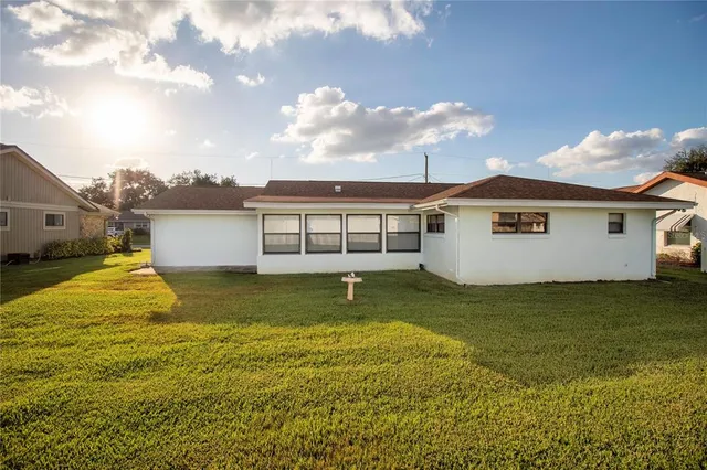 a view of a house with a backyard
