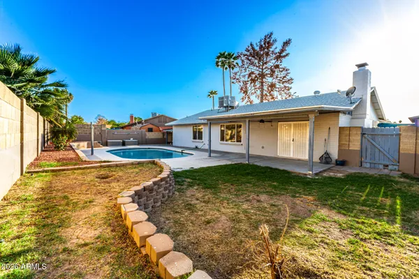 a view of a house with a backyard