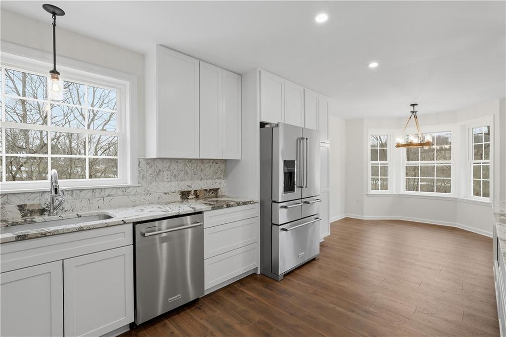 5149 Watters Road Lower Burrell, PA 15068 - Photo 12 of 49 a kitchen with white cabinets and wooden floor