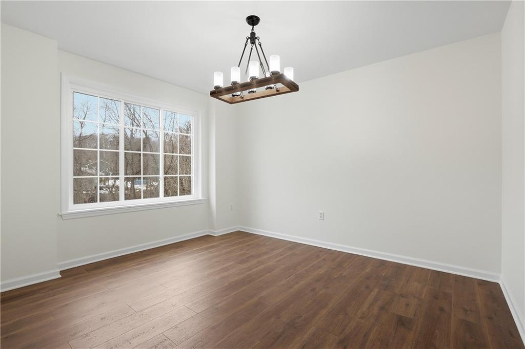 5149 Watters Road Lower Burrell, PA 15068 - Photo 19 of 49 an empty room with wooden floor chandelier and windows