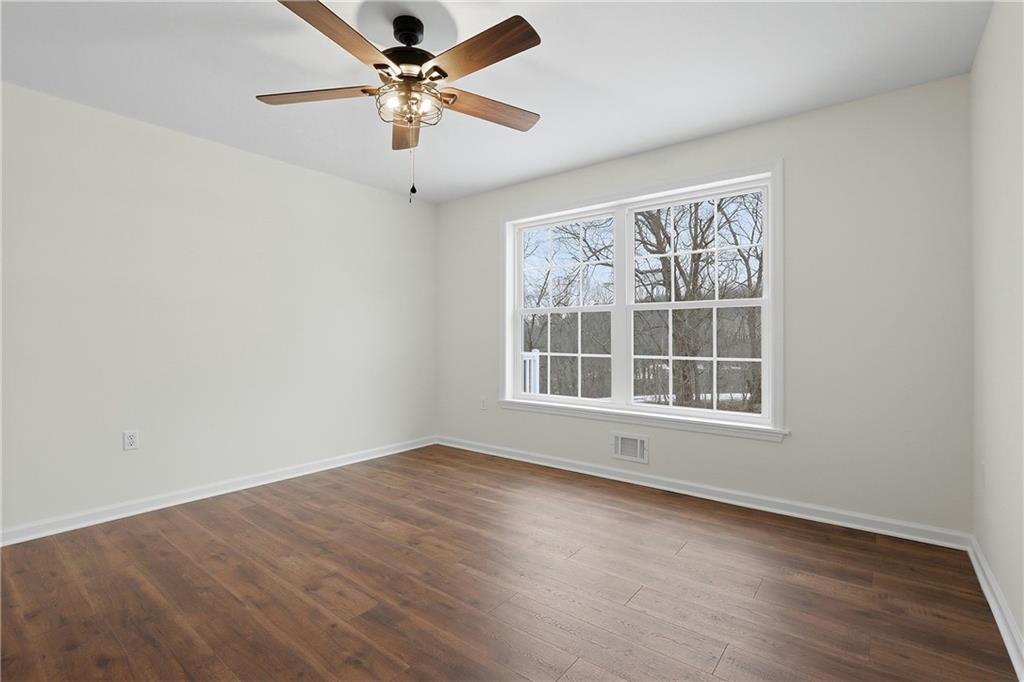 5149 Watters Road Lower Burrell, PA 15068 - Photo 23 of 49 an empty room with wooden floor fan and windows