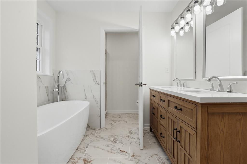 5149 Watters Road Lower Burrell, PA 15068 - Photo 24 of 49 a bathroom with a tub a sink and a mirror