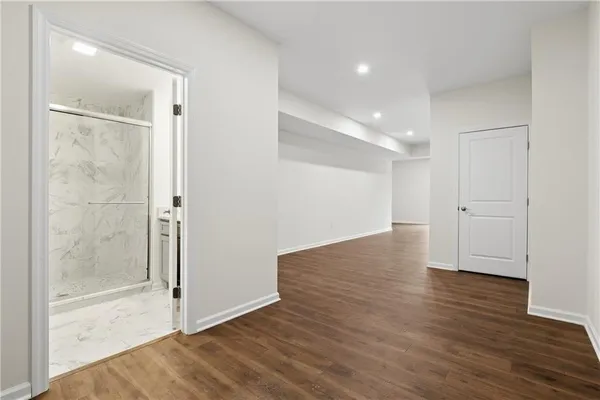 a view of empty room with wooden floor