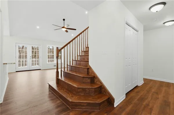 a view of entryway and hall with wooden floor