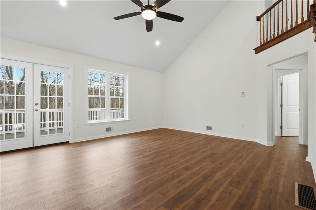 5149 Watters Road Lower Burrell, PA 15068 - Photo 7 of 49 an empty room with wooden floor chandelier fan and windows