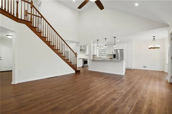 a view of kitchen and hall with wooden floor