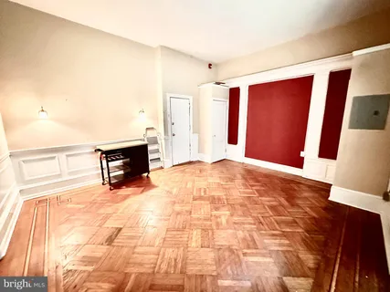 a view of empty room with wooden floor
