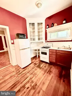 a kitchen with a stove a sink and a microwave