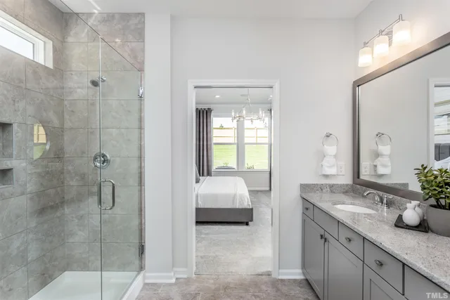 a living room with furniture a large window and a chandelier