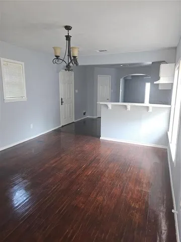 a view of a kitchen with wooden floor and a ceiling fan