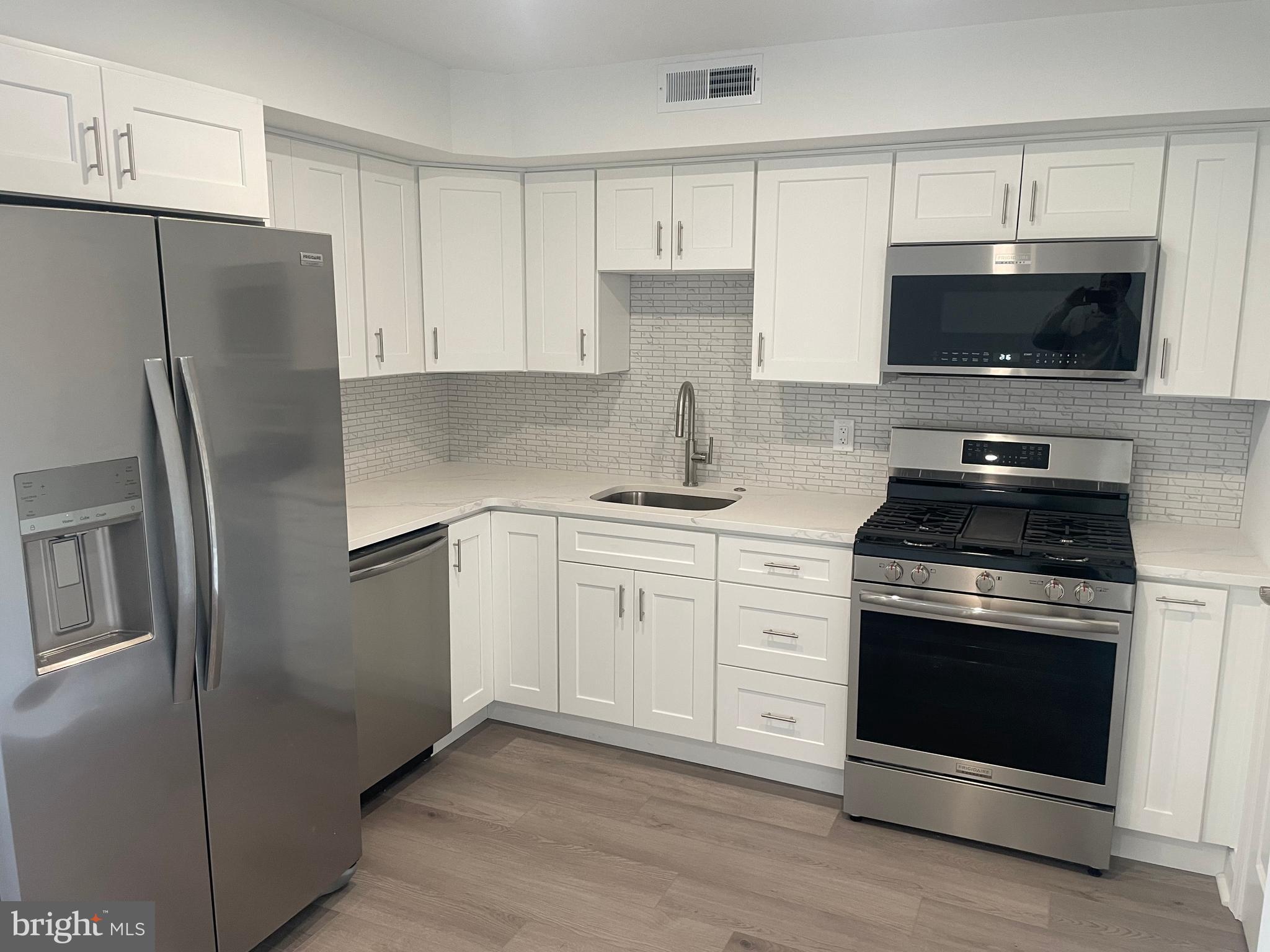 a kitchen with a stove microwave and refrigerator