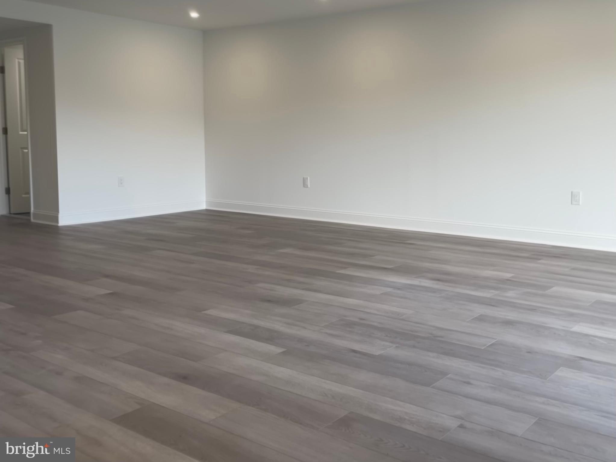 9906 Bustleton Avenue, Unit F3 Philadelphia, PA 19115 - Photo 6 of 8 a view of an empty room with wooden floor