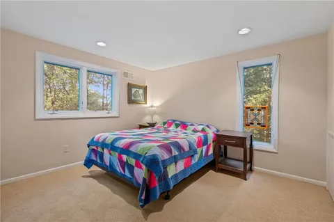 a view of a hallway with furniture and wooden floor