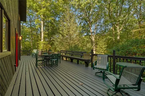 a big yard with lots of green space and trees all around