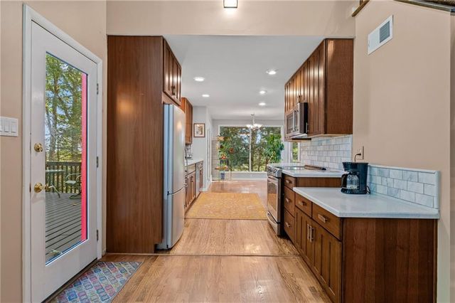 a kitchen with stainless steel appliances granite countertop a stove a sink and a refrigerator