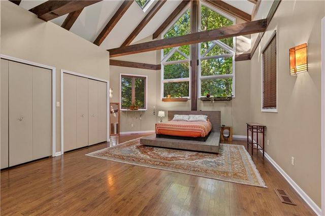 a bedroom with furniture and large window
