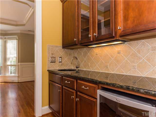 8677 Barrett Ridge Road Wake Forest, NC 27587 - Photo 5 of 25 The butler's pantry has granite counters, tile back splash and wine cooler that conveys with the sale of this lovely property. Other