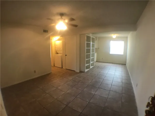 an empty room with a empty space and windows