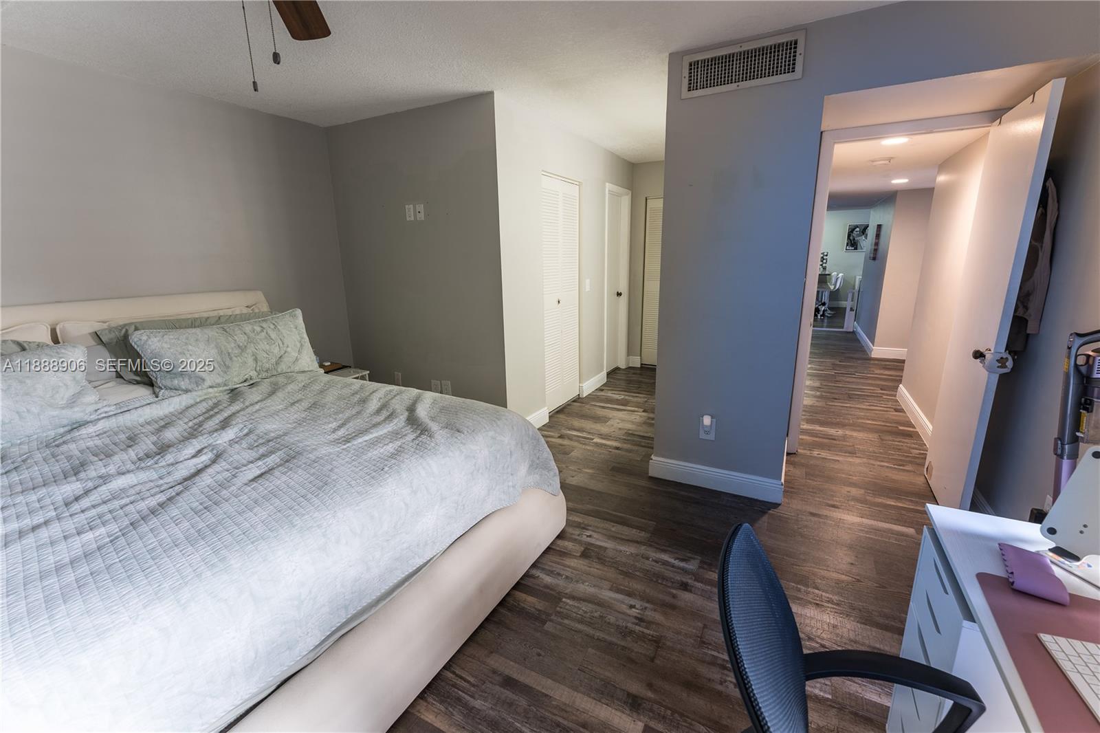 8810 Southwest 132nd Place, Unit 404DN Miami, FL 33186 - Photo 16 of 20 a bedroom with bed and wooden floor