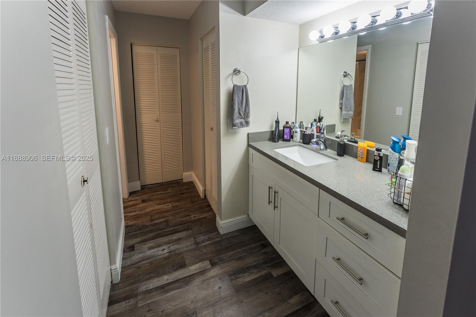 8810 Southwest 132nd Place, Unit 404DN Miami, FL 33186 - Photo 17 of 20 a bathroom with a double vanity sink and mirror