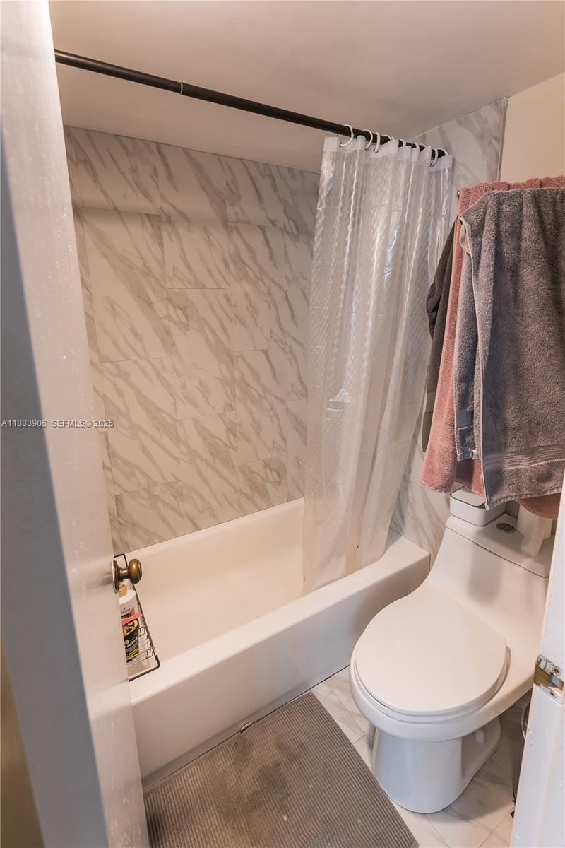 8810 Southwest 132nd Place, Unit 404DN Miami, FL 33186 - Photo 19 of 20 a bathroom with a toilet and a shower