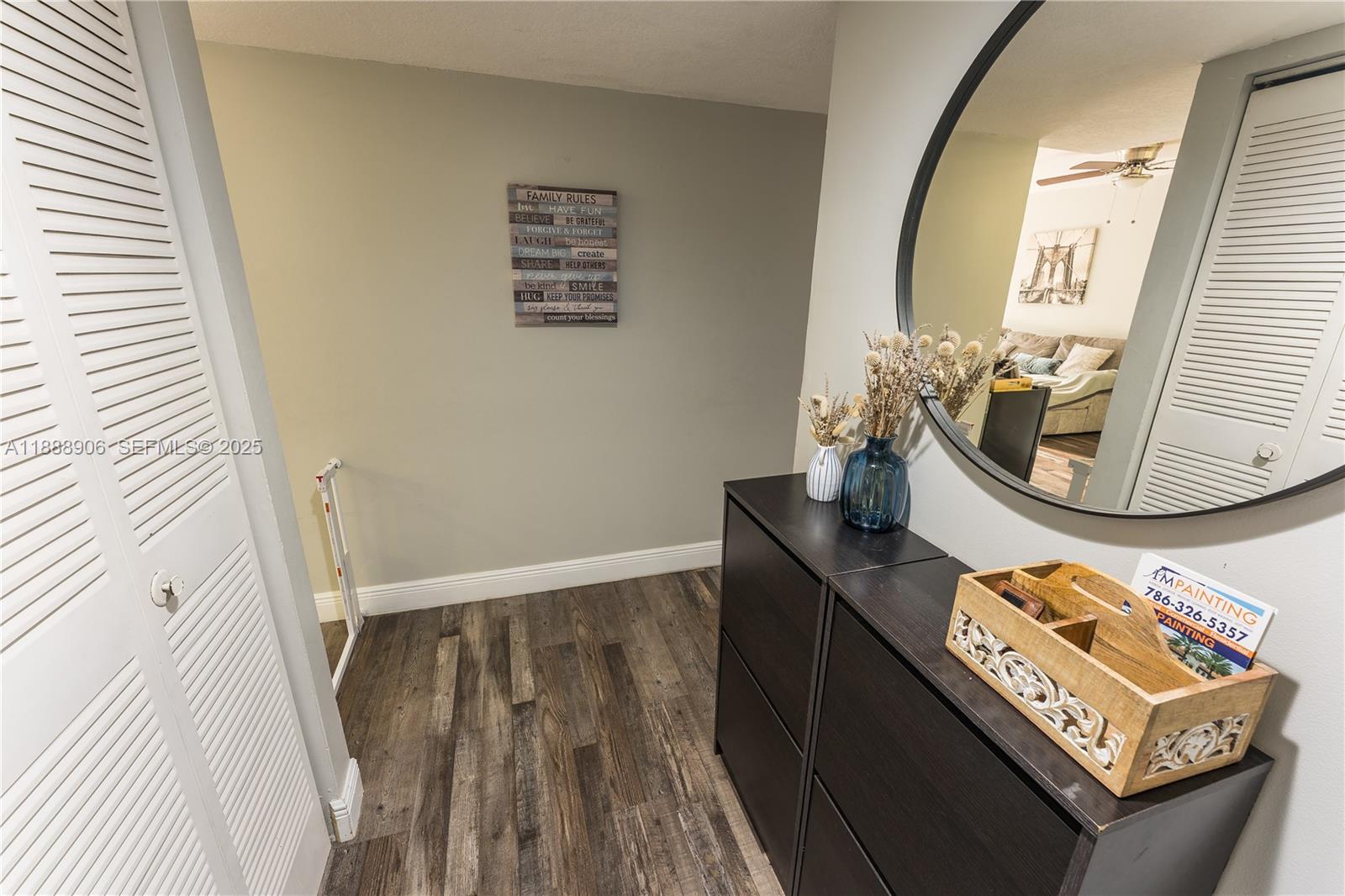 8810 Southwest 132nd Place, Unit 404DN Miami, FL 33186 - Photo 4 of 20 a view of a hallway with wooden floor and front door