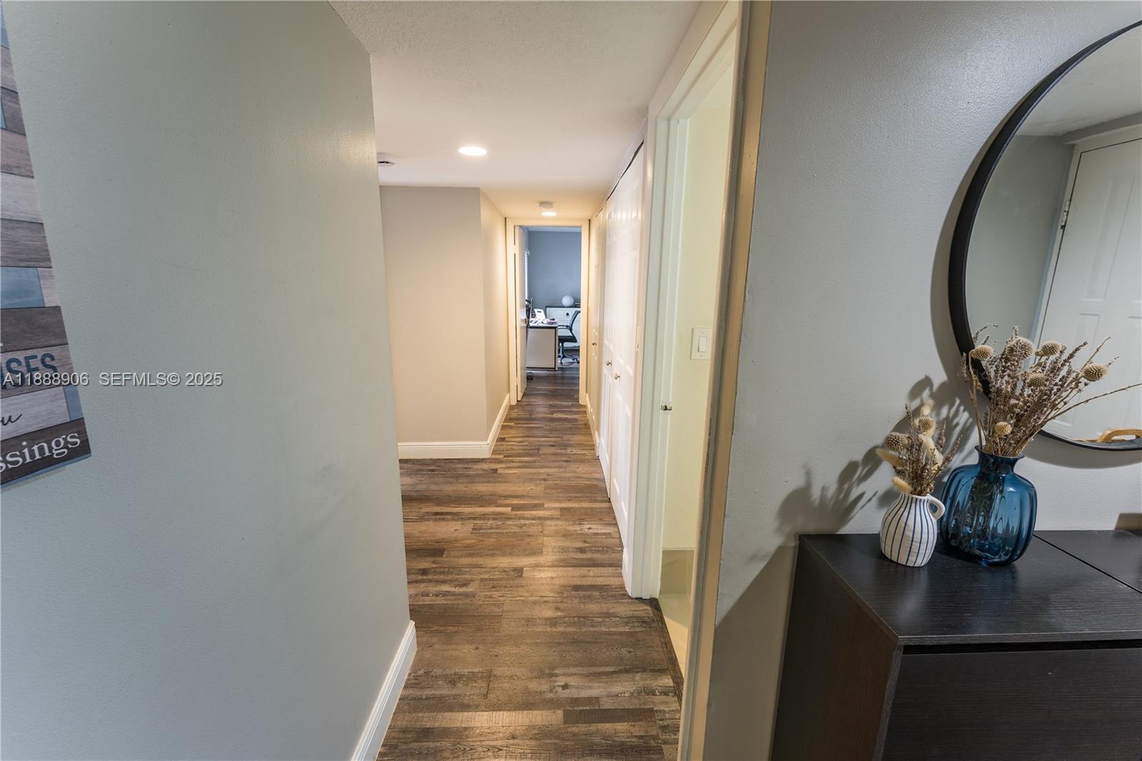 8810 Southwest 132nd Place, Unit 404DN Miami, FL 33186 - Photo 5 of 20 a view of a hallway with wooden floor and a potted plant