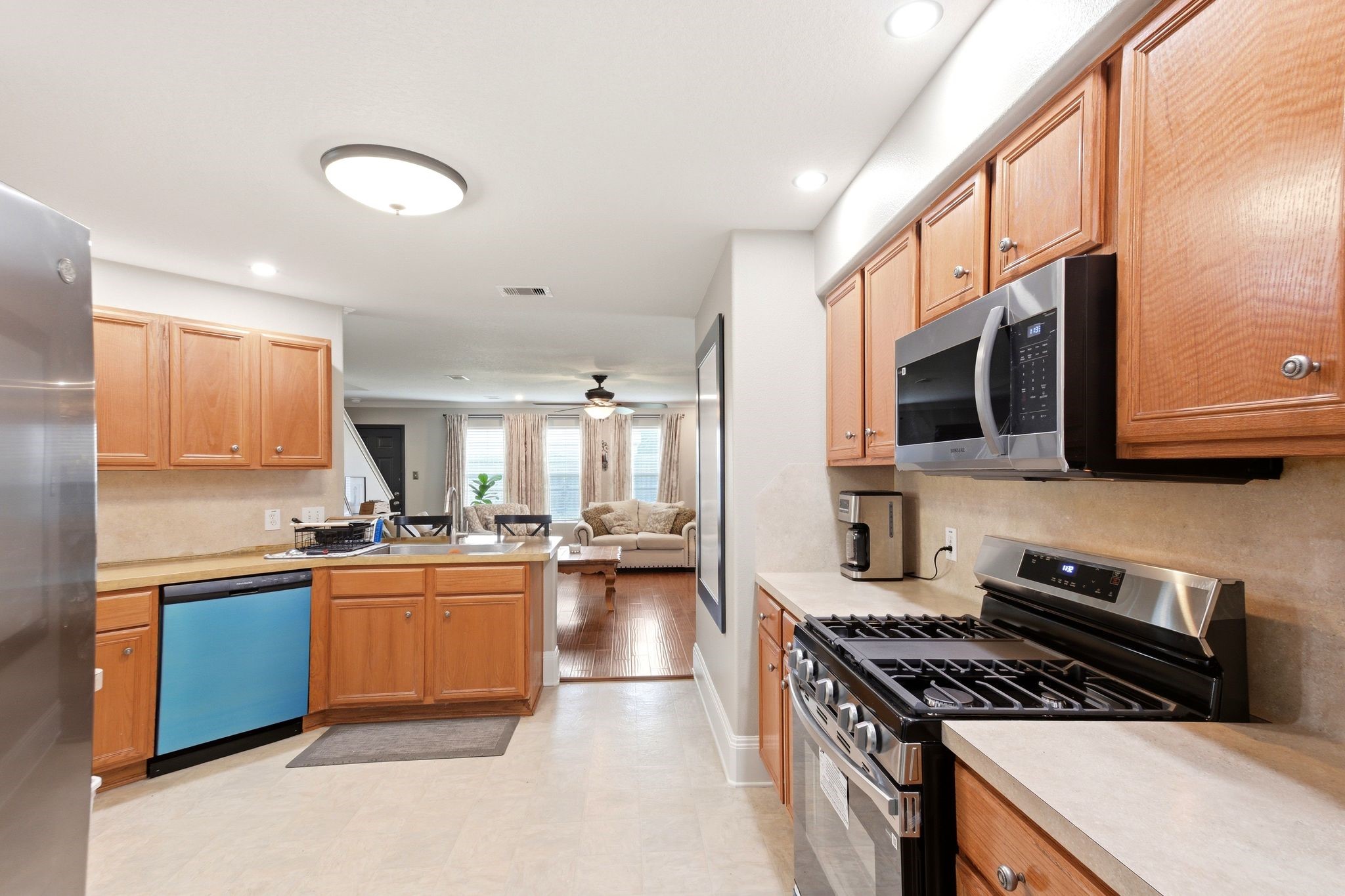 16954 Tableland Trail Conroe, TX 77385 - Photo 11 of 33 Well-equipped kitchen with ample cabinet storage, stainless steel appliances, gas range, and abundant prep space. Open to the living area, creating a seamless flow for entertaining and everyday living.