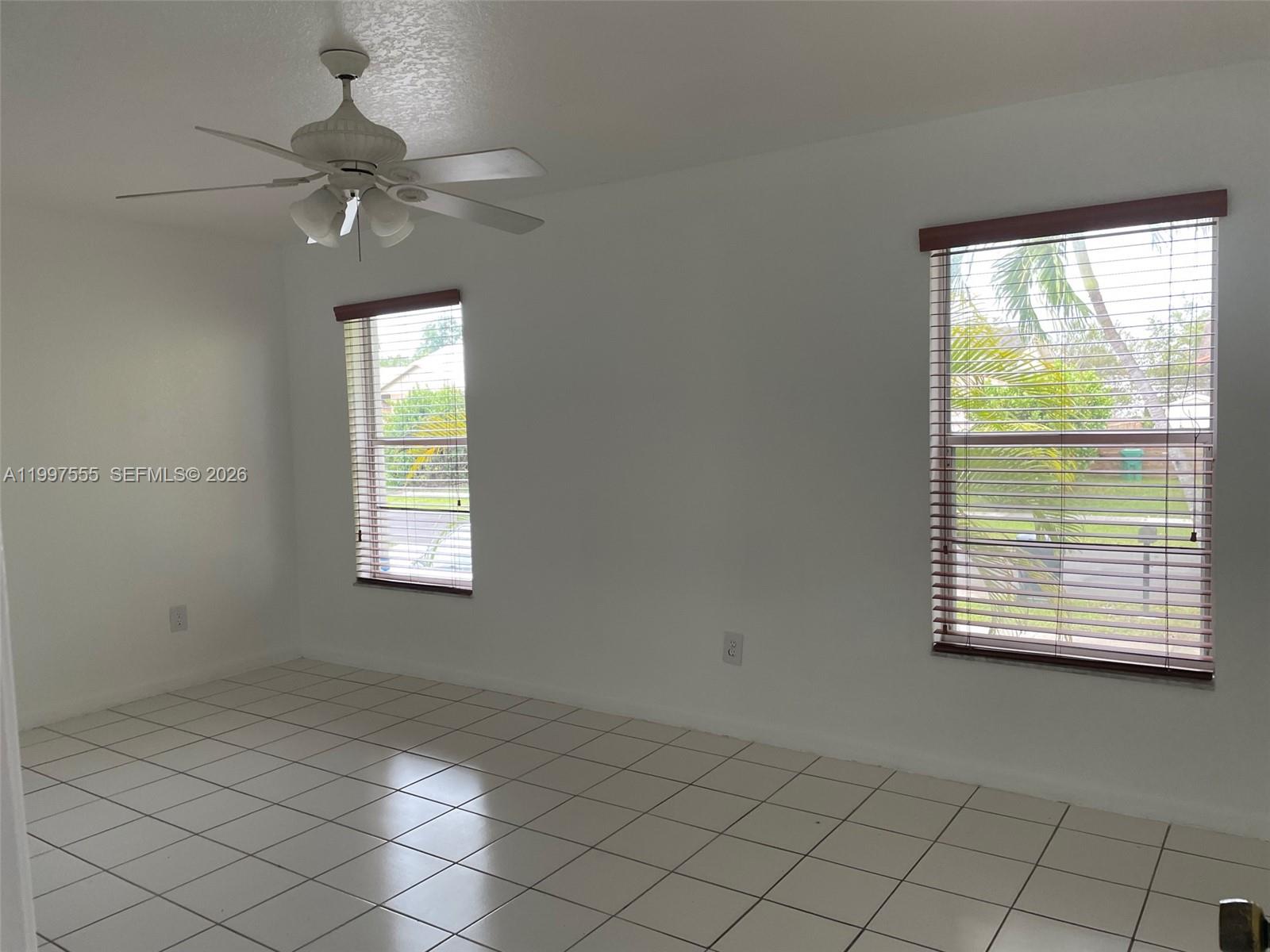 9771 Southwest 211 Street Cutler Bay, FL 33189 - Photo 14 of 19 an empty room with windows and fan