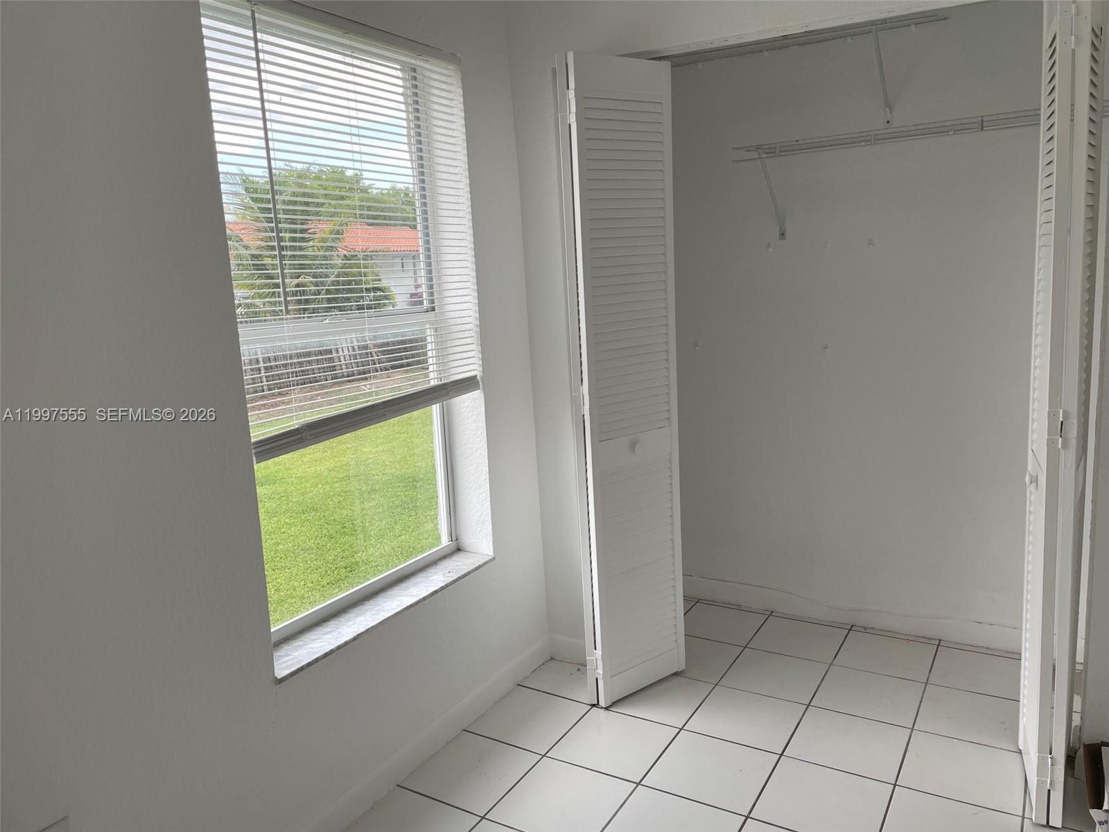 9771 Southwest 211 Street Cutler Bay, FL 33189 - Photo 18 of 19 a view of an empty room with a window