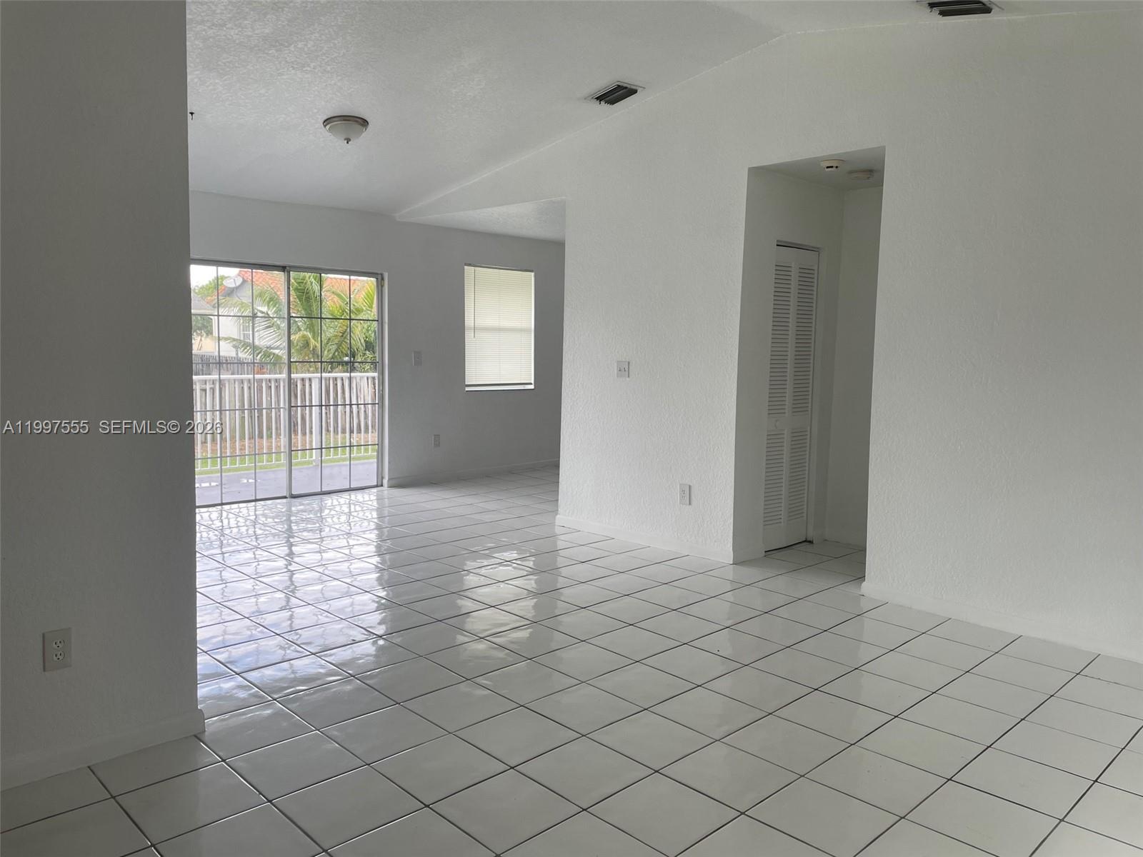 9771 Southwest 211 Street Cutler Bay, FL 33189 - Photo 6 of 19 a view of an empty room and window