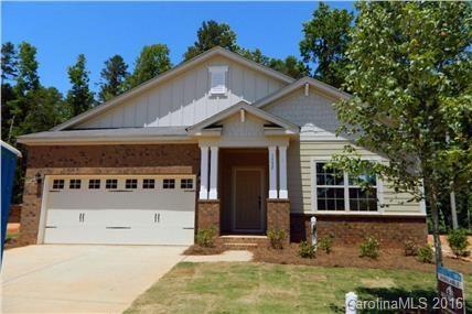 1532 Spring Blossom Trail, Unit SITE 41 Fort Mill, SC 29708 - Photo 1 of 20 a front view of a house with a yard garage and a tree