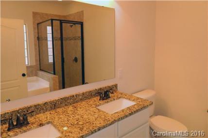 1532 Spring Blossom Trail, Unit SITE 41 Fort Mill, SC 29708 - Photo 20 of 20 a bathroom with a granite countertop sink and a mirror