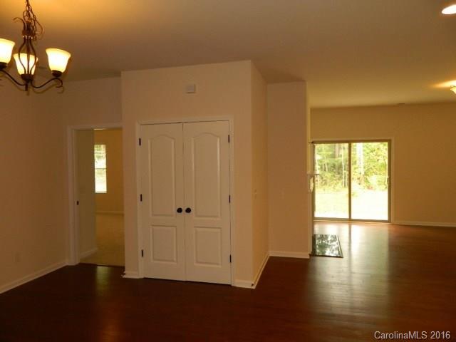 1532 Spring Blossom Trail, Unit SITE 41 Fort Mill, SC 29708 - Photo 5 of 20 a view of an empty room with wooden floor and a window