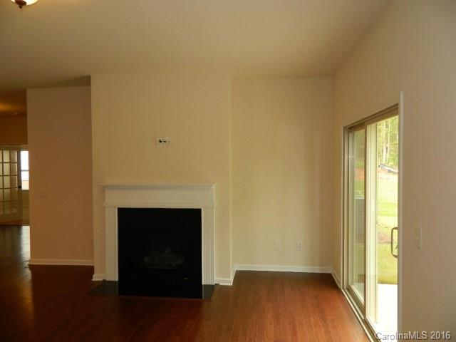 1532 Spring Blossom Trail, Unit SITE 41 Fort Mill, SC 29708 - Photo 8 of 20 a view of an empty room with wooden floor and a window