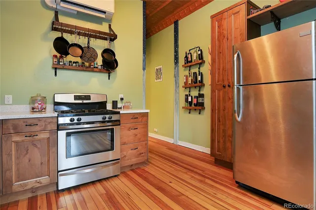 a kitchen with stainless steel appliances granite countertop a refrigerator and a stove top oven