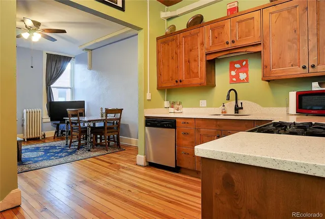 a kitchen with a sink cabinets and wooden floor