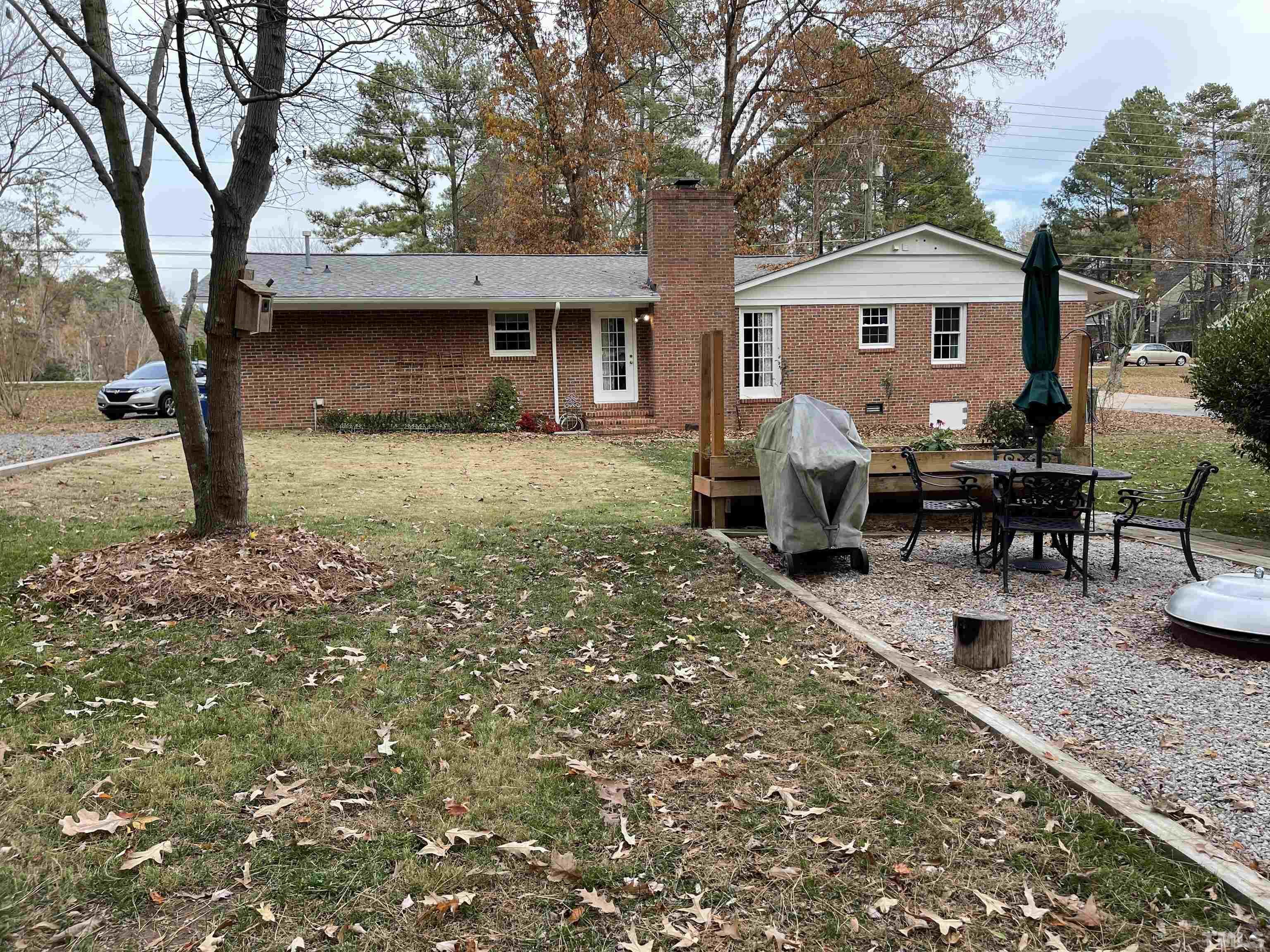7701 Leesville Road Raleigh, NC 27613 - Photo 2 of 33 a view of a house with backyard and sitting area