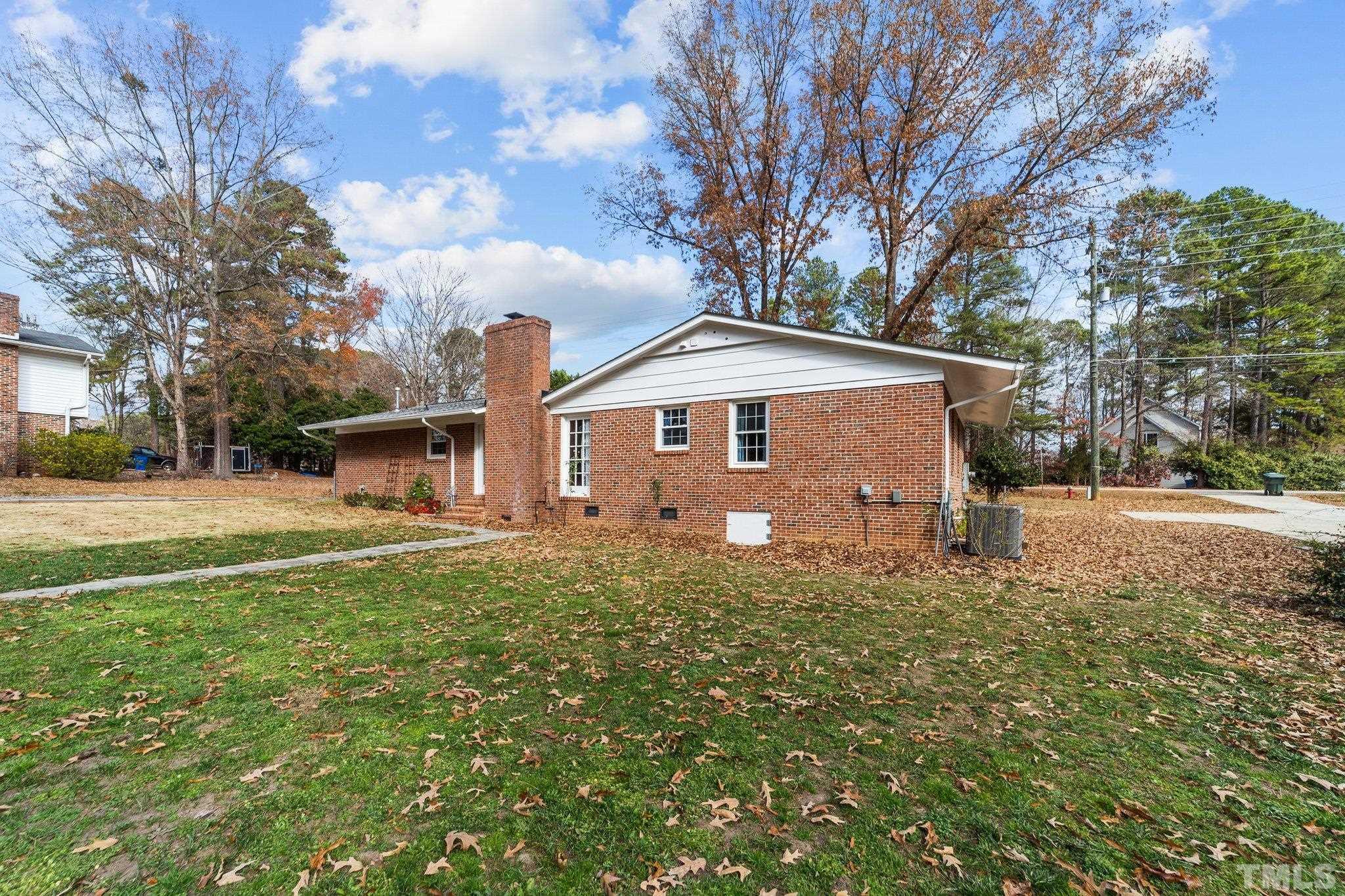 7701 Leesville Road Raleigh, NC 27613 - Photo 11 of 33 a front view of a house with garden