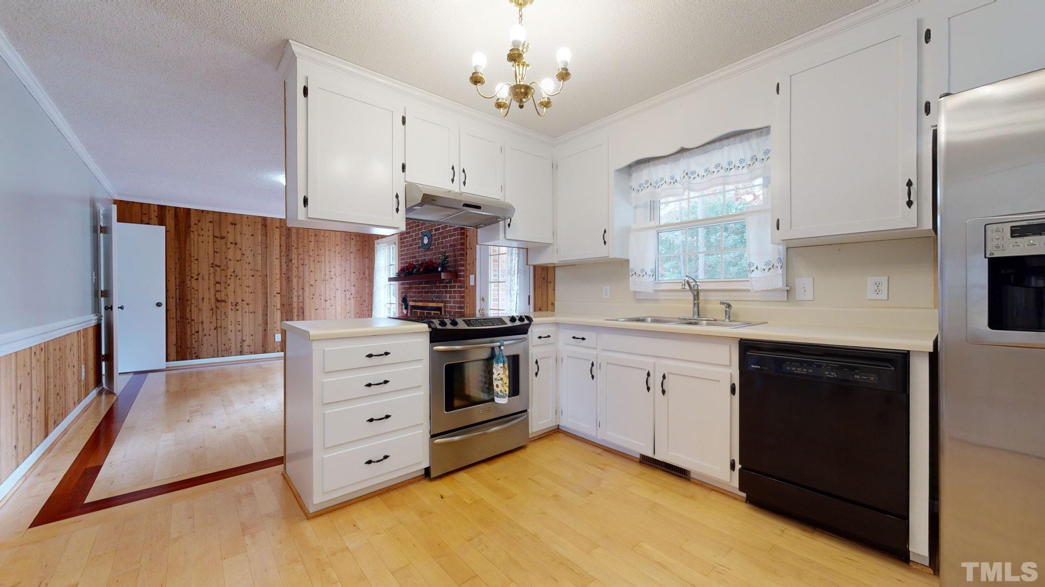 7701 Leesville Road Raleigh, NC 27613 - Photo 19 of 33 a kitchen with stainless steel appliances a stove a sink and a refrigerator