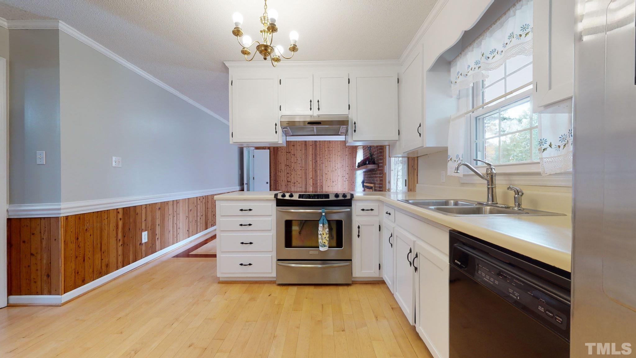 7701 Leesville Road Raleigh, NC 27613 - Photo 20 of 33 a kitchen with stainless steel appliances granite countertop a stove and a sink