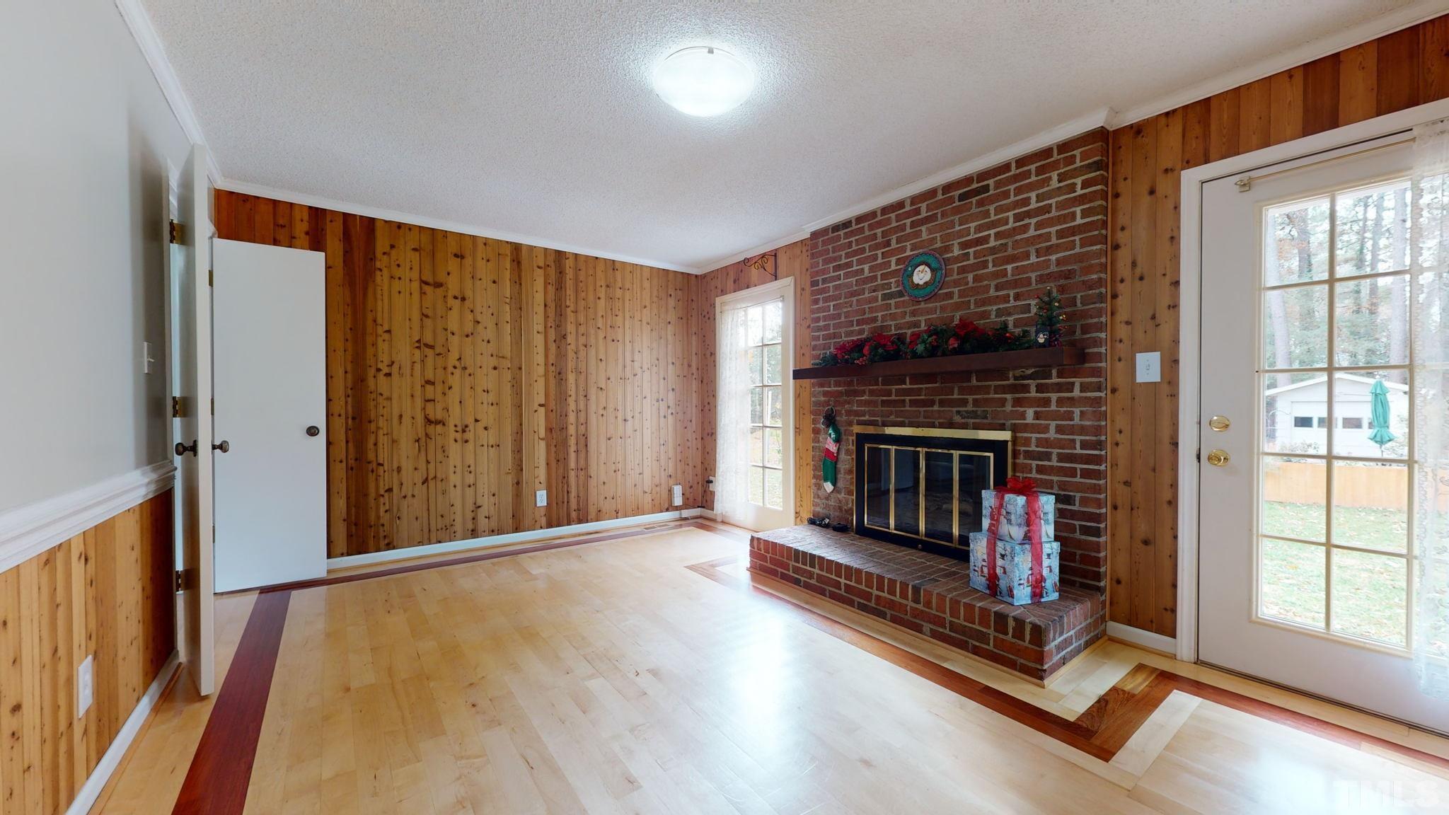 7701 Leesville Road Raleigh, NC 27613 - Photo 22 of 33 wooden floor in an empty room with a fireplace
