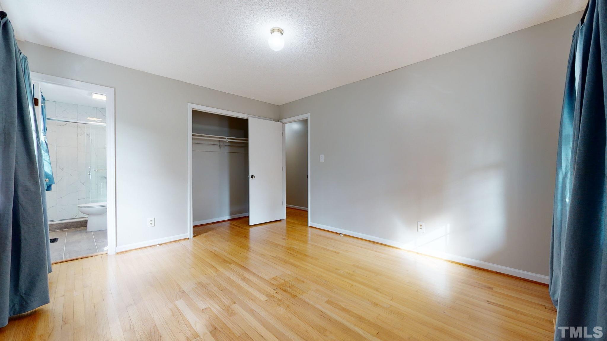 7701 Leesville Road Raleigh, NC 27613 - Photo 26 of 33 a view of an empty room with wooden floor and a window