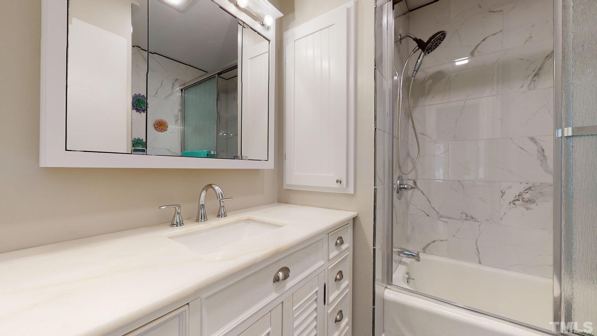 7701 Leesville Road Raleigh, NC 27613 - Photo 33 of 33 a bathroom with a sink and a mirror