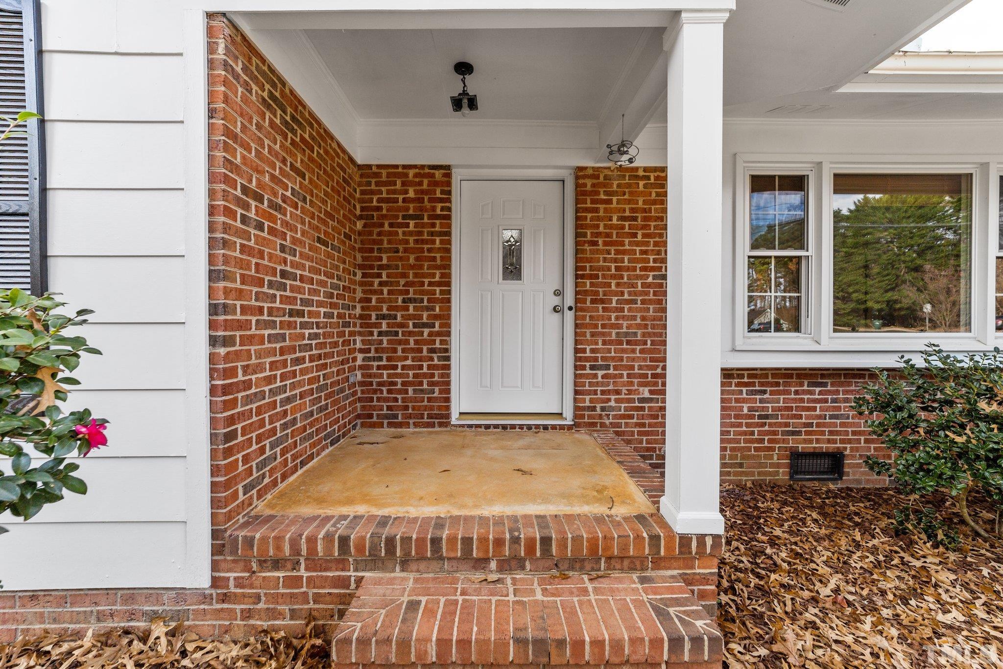 7701 Leesville Road Raleigh, NC 27613 - Photo 6 of 33 a view of a entryway door front of house