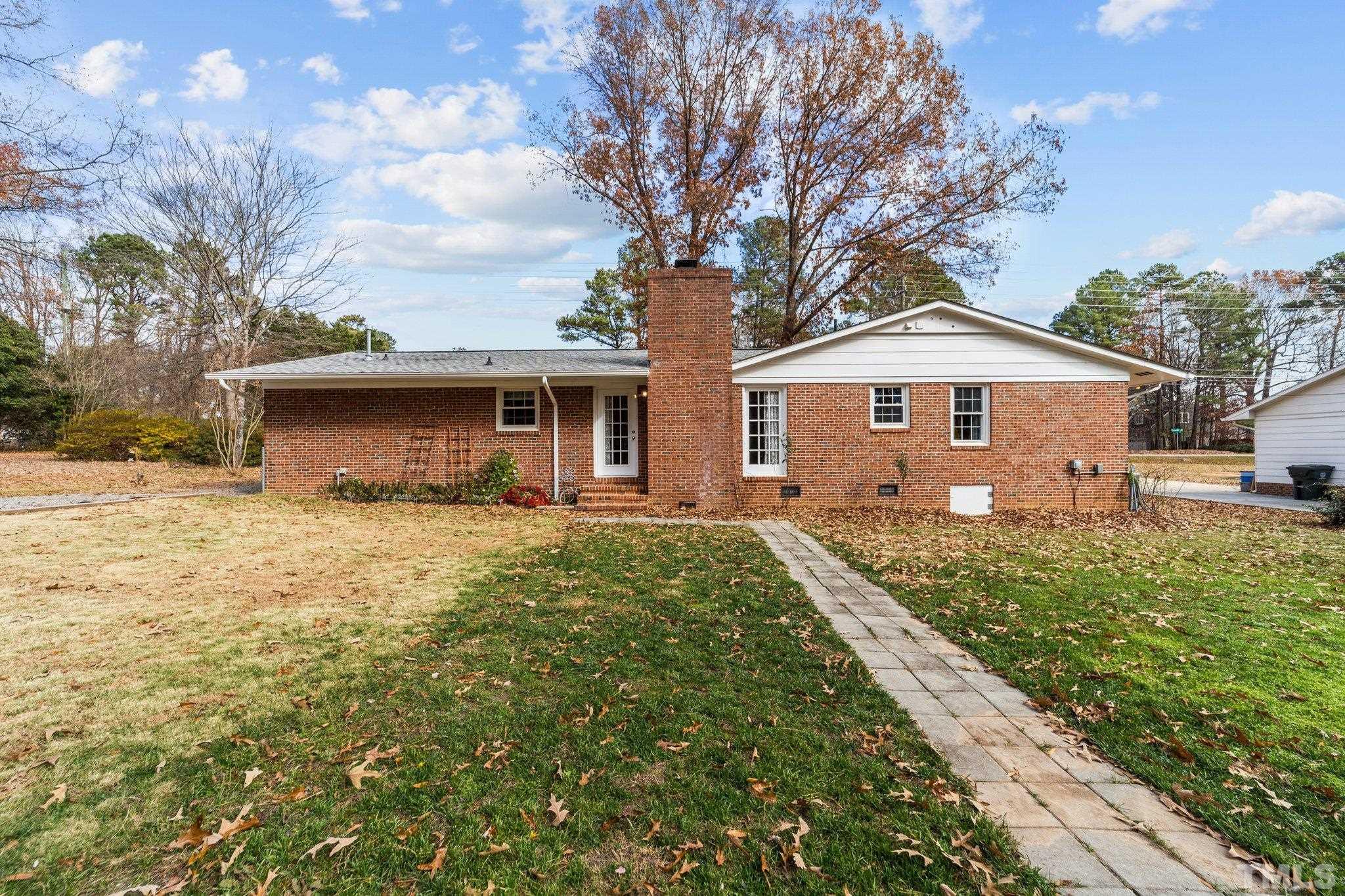 7701 Leesville Road Raleigh, NC 27613 - Photo 10 of 33 a front view of a house with a garden