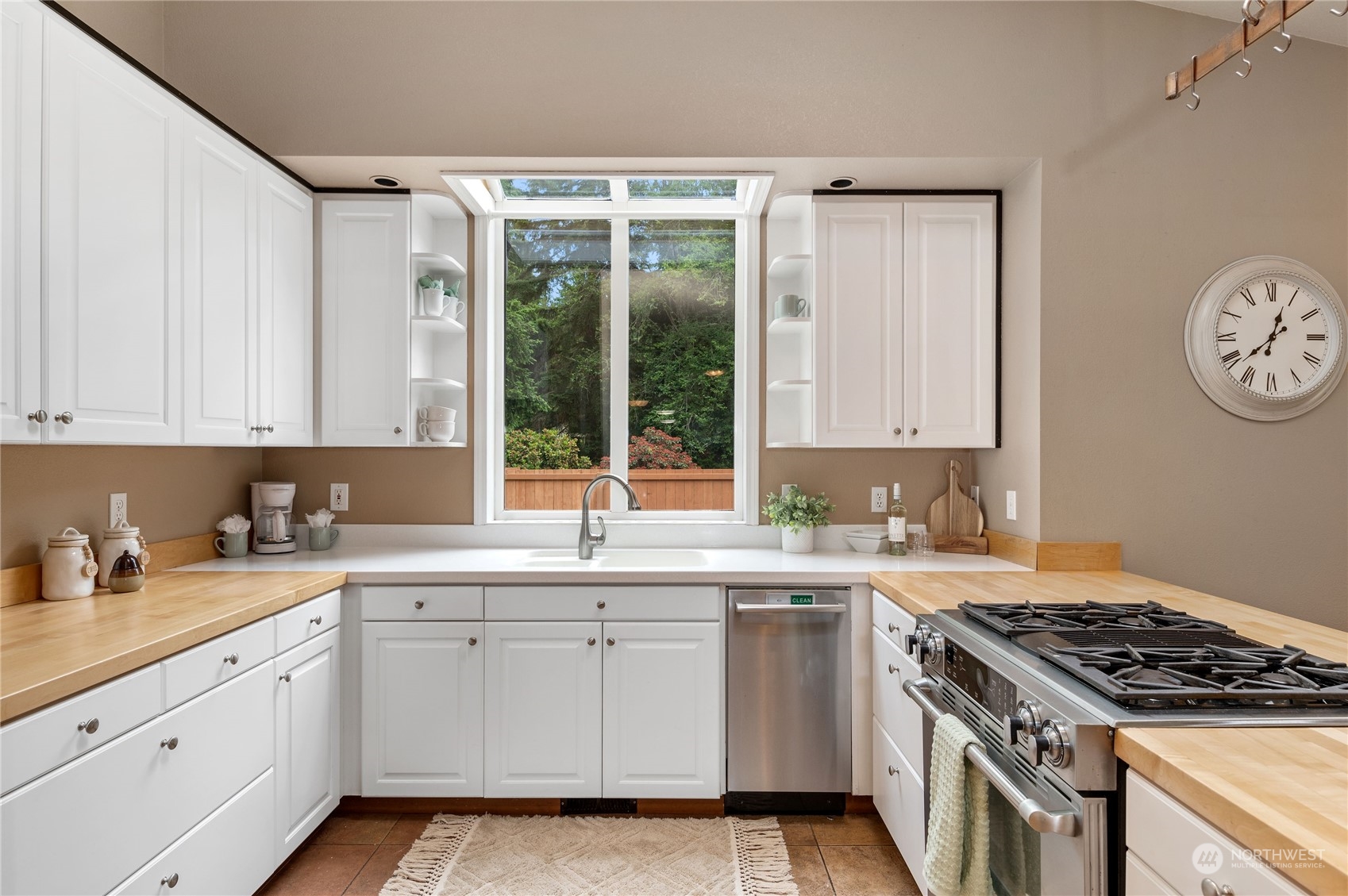 3860 Northeast Iverson Road Poulsbo, WA 98370 - Photo 15 of 40 a kitchen with a sink stove top oven and cabinets
