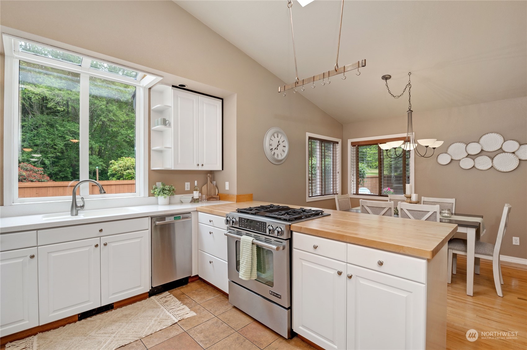 3860 Northeast Iverson Road Poulsbo, WA 98370 - Photo 16 of 40 a kitchen that has a sink a stove and a table in it
