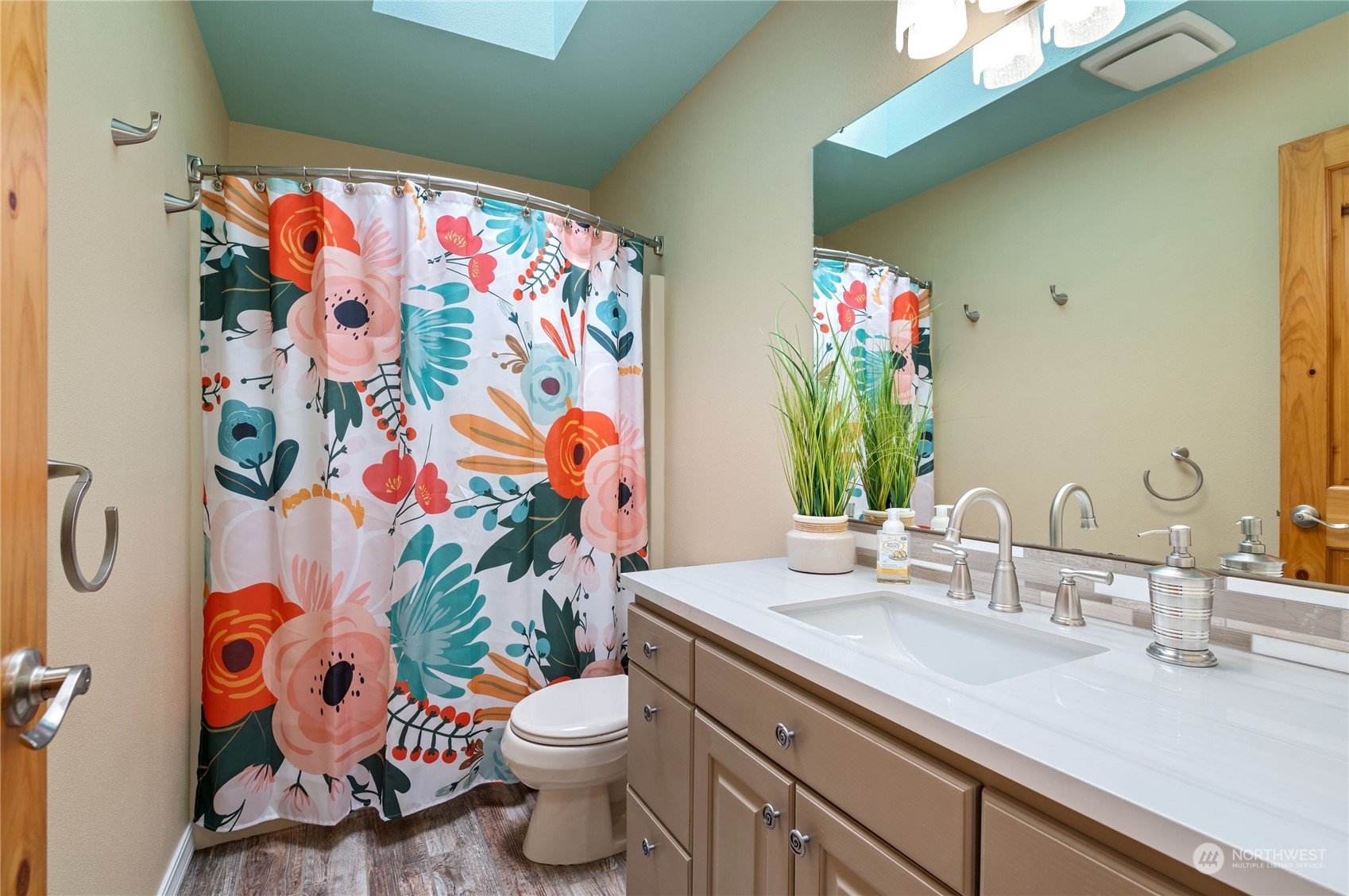 3860 Northeast Iverson Road Poulsbo, WA 98370 - Photo 20 of 40 a bathroom with a sink mirror vanity and toilet